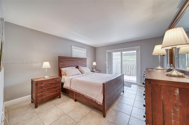 bedroom with access to exterior and light tile patterned floors