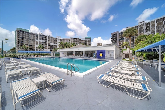 view of pool featuring a fireplace and a patio area