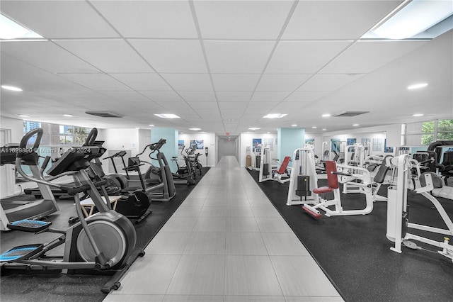 gym with a paneled ceiling