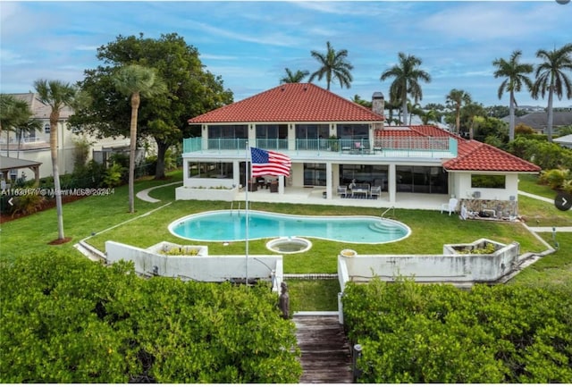 rear view of house featuring a lawn and a patio area