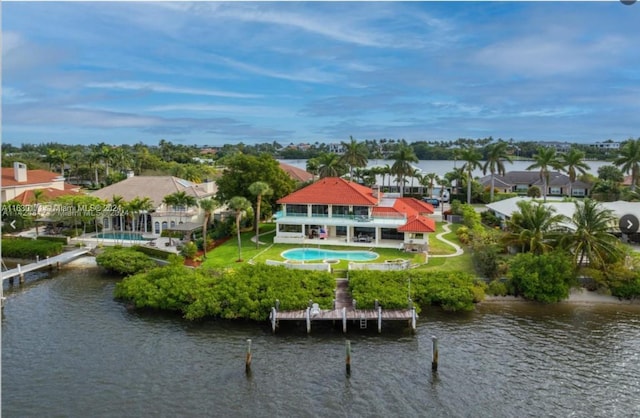 back of property with a patio and a water view