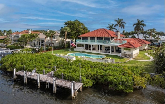 rear view of house featuring a water view and a patio area
