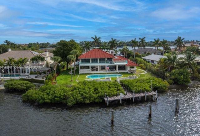 rear view of house featuring a water view and a patio