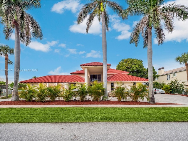 mediterranean / spanish house featuring a front lawn