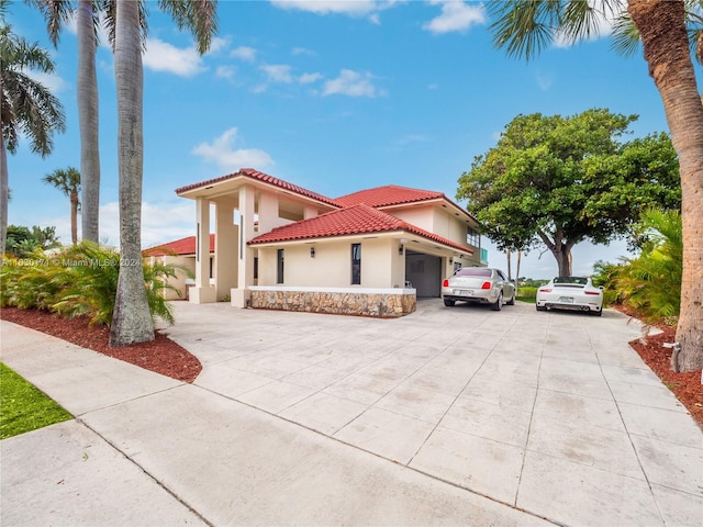 mediterranean / spanish-style home with a garage