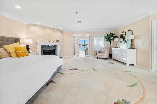 bedroom with ornamental molding, a premium fireplace, and light colored carpet