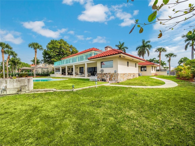 rear view of property with a yard