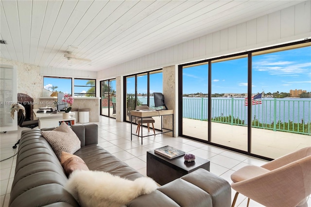 tiled living room with a water view and wood ceiling