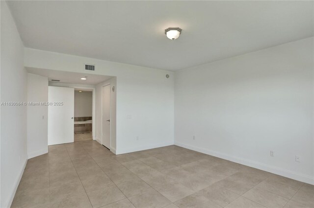 empty room with light tile patterned floors