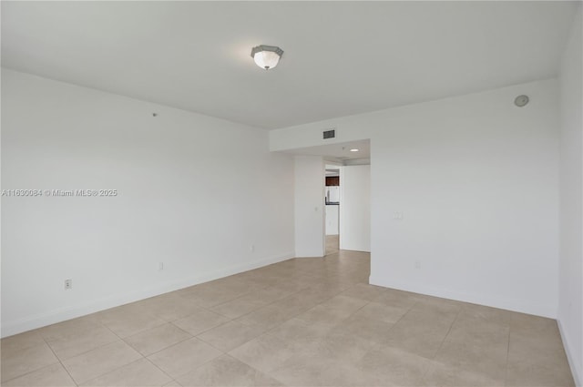 spare room with light tile patterned floors