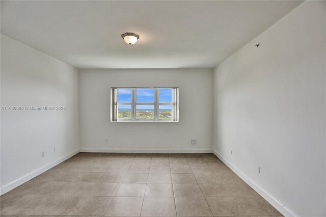 unfurnished room with light tile patterned floors