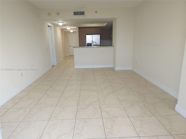 unfurnished room with sink and light tile patterned floors