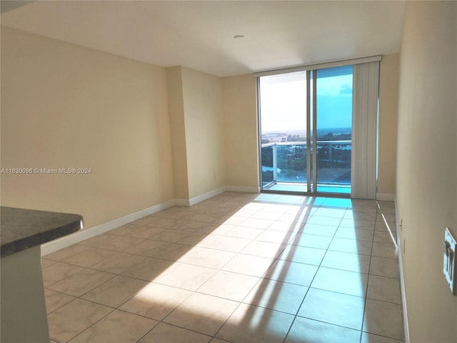 tiled spare room with expansive windows