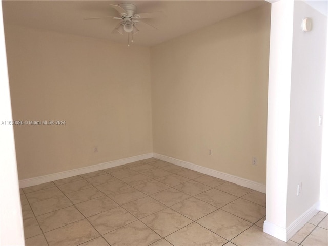 spare room with light tile patterned flooring and ceiling fan