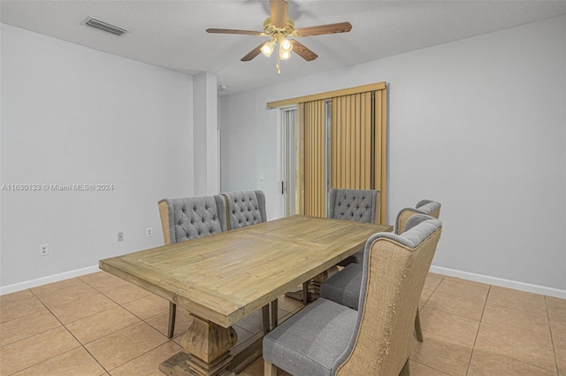 dining area featuring a textured ceiling, tile patterned floors, and ceiling fan