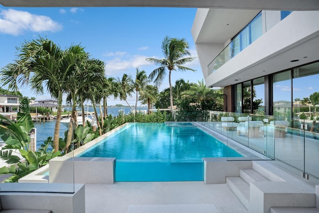 view of pool featuring a water view