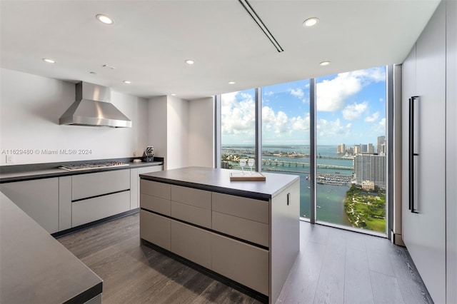 788 NE 23rd St Unit 4601, Miami, FL 33137 - kitchen featuring wall chimney range hood, modern cabinets, stainless steel gas cooktop, dark wood-style flooring, and floor to ceiling windows