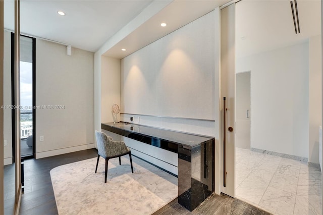 office space featuring hardwood / wood-style floors and floor to ceiling windows