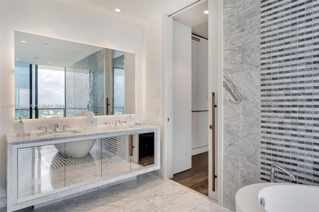 bathroom featuring independent shower and bath, tile patterned floors, and double sink vanity