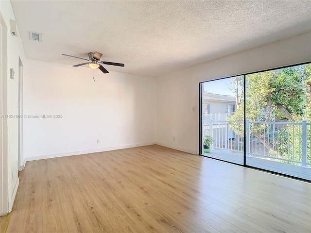 unfurnished room with ceiling fan, light hardwood / wood-style floors, and a textured ceiling