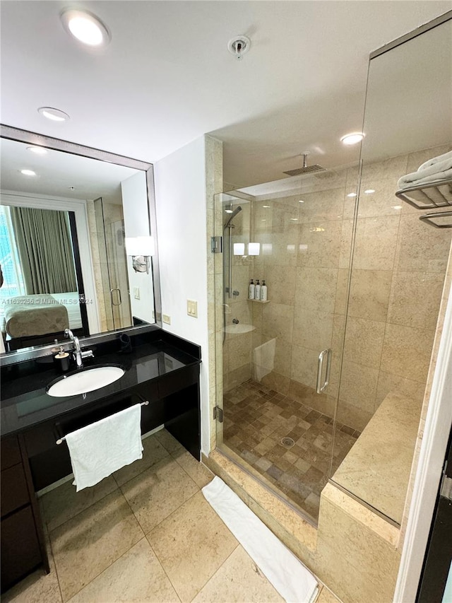 bathroom featuring an enclosed shower and vanity