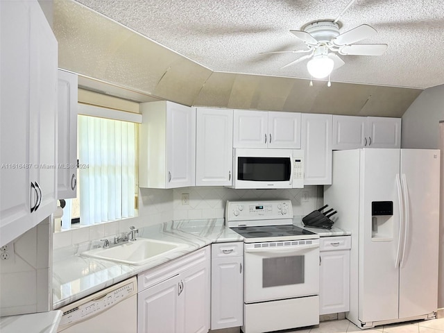 kitchen featuring backsplash, white appliances, a wealth of natural light, and ceiling fan