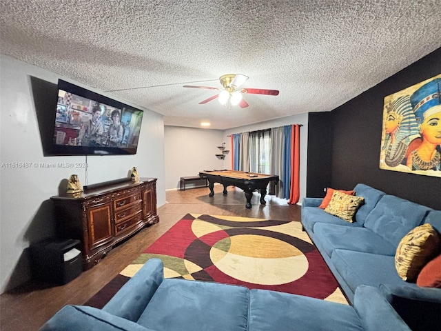 living room with pool table, a textured ceiling, ceiling fan, and hardwood / wood-style floors