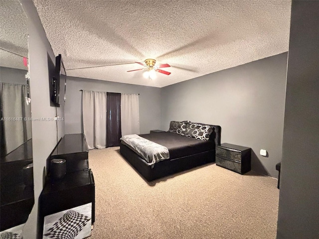 bedroom featuring carpet, a textured ceiling, and ceiling fan