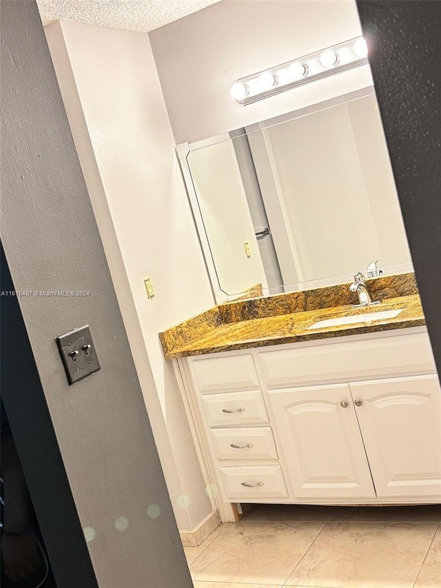 bathroom with vanity, tile patterned floors, and a textured ceiling