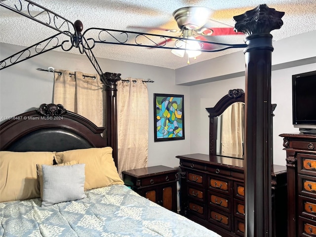 bedroom with ceiling fan and a textured ceiling