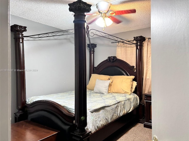 bedroom with carpet, a textured ceiling, and ceiling fan