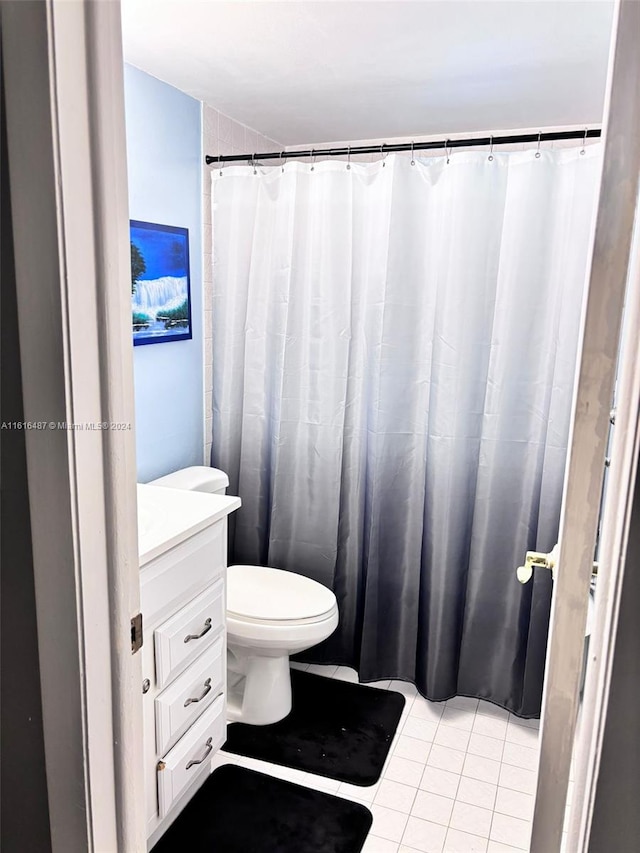 bathroom with tile patterned floors, vanity, and toilet