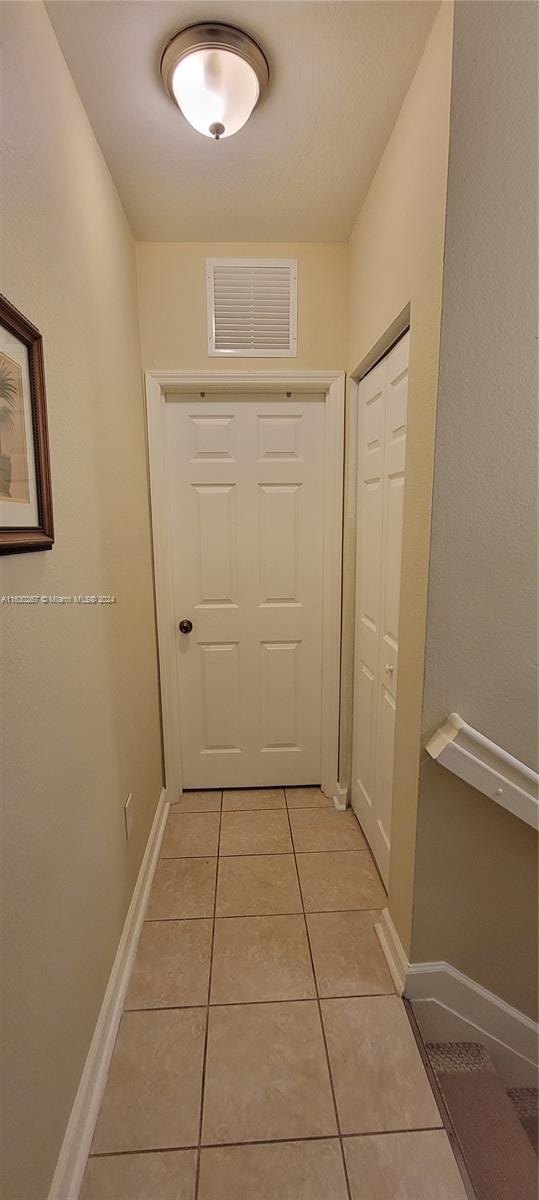 hallway with light tile patterned floors