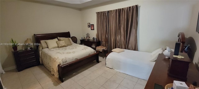 bedroom with light tile patterned floors