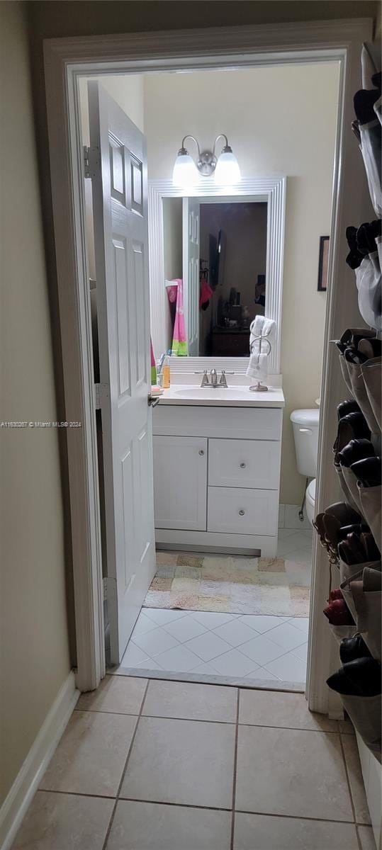 bathroom with tile patterned flooring, toilet, and vanity