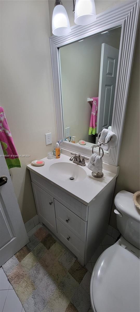 bathroom with tile patterned floors, toilet, and vanity