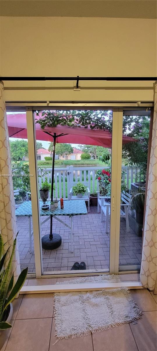 doorway with tile patterned floors