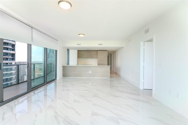 tiled spare room with expansive windows