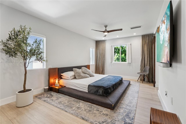 bedroom with light hardwood / wood-style flooring and ceiling fan