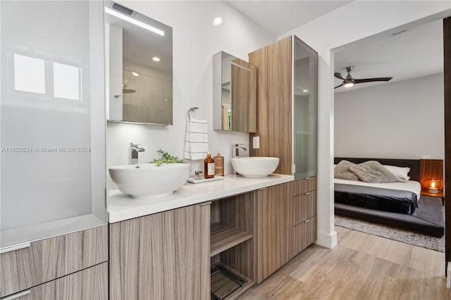 bathroom featuring vanity, a shower, hardwood / wood-style flooring, and ceiling fan