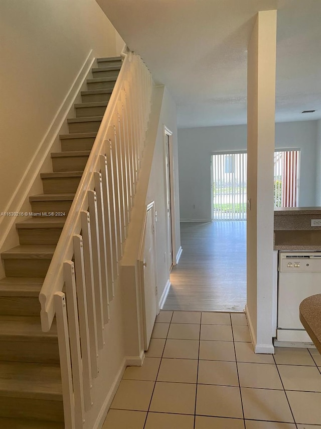 stairs featuring tile patterned flooring