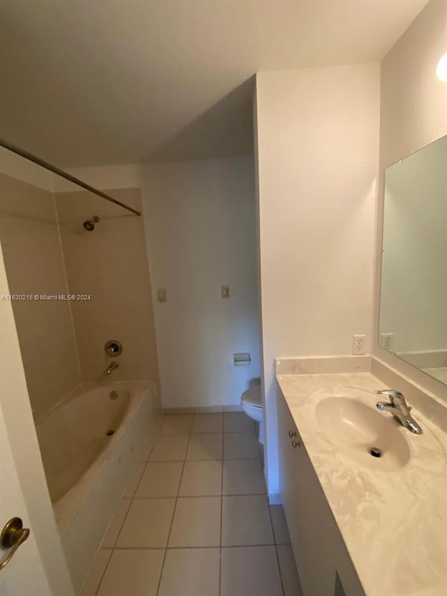 full bathroom with tile patterned floors, toilet, tiled shower / bath combo, and vanity