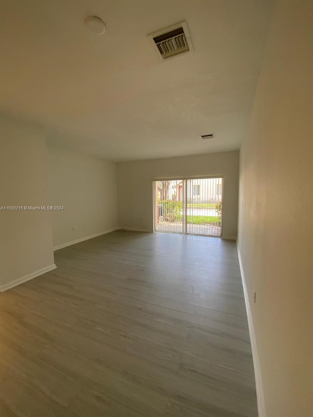 spare room with hardwood / wood-style floors