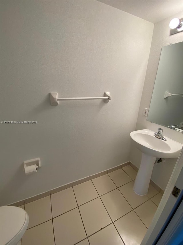 bathroom featuring tile patterned floors and toilet