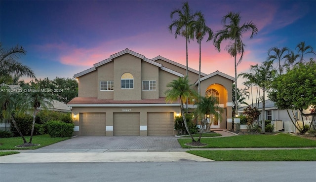 view of front of house with a yard and a garage