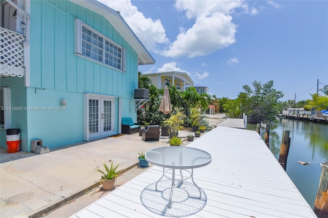 exterior space featuring central AC unit, a patio area, an outdoor hangout area, and a water view