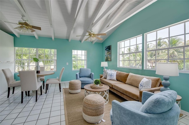 living room with vaulted ceiling with beams, ceiling fan, and light tile patterned floors