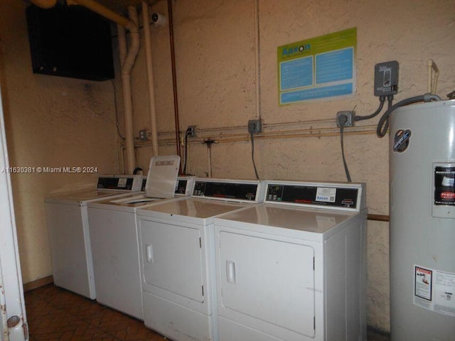 washroom with electric water heater and washing machine and clothes dryer