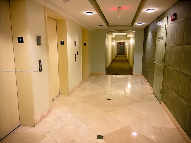 2080 S Ocean Dr Unit 701, Hallandale Beach, FL 33009 - hall with arched walkways, elevator, and baseboards