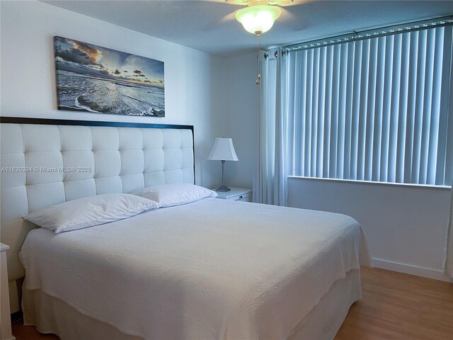 bedroom featuring wood-type flooring and ceiling fan